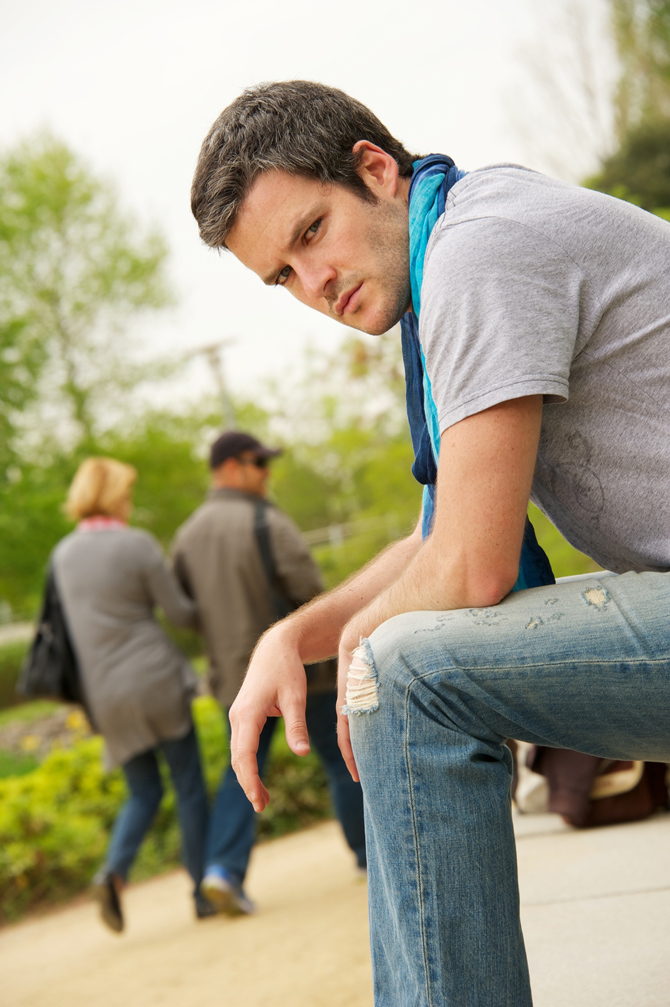 Young man and walking couple on a blurred background