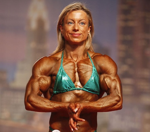 shredded female bodybuilder in green bikini