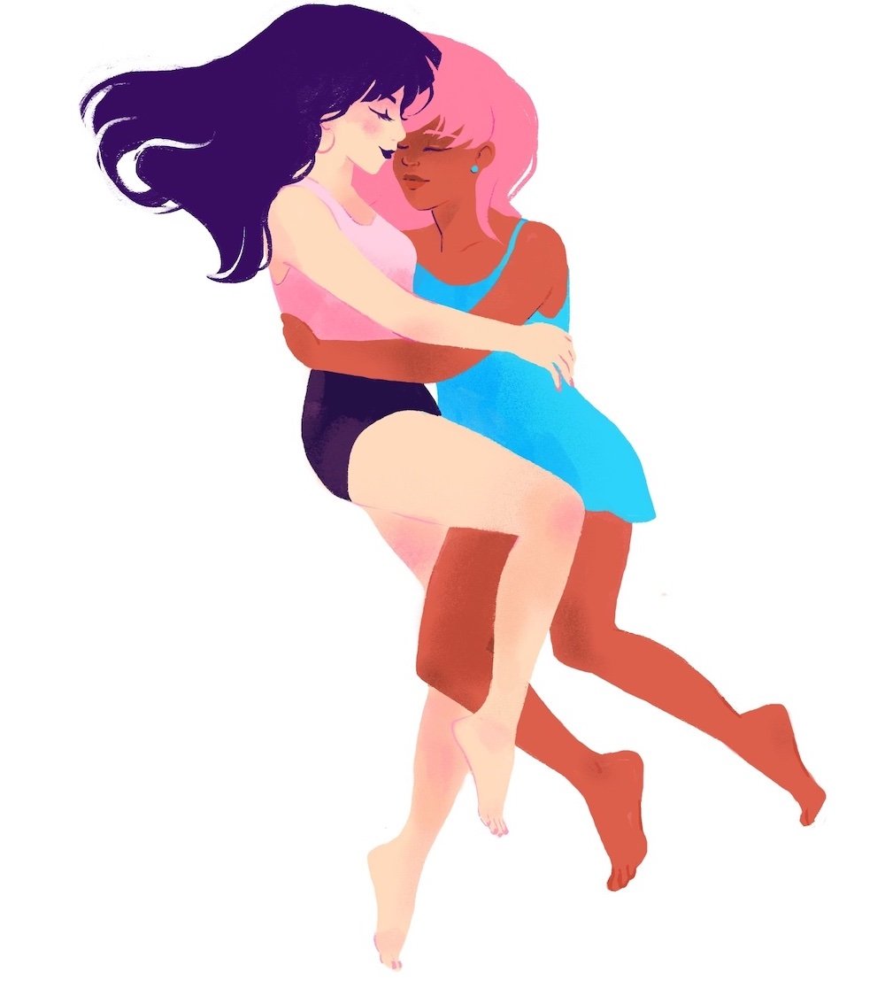 two women facing each other on their sides and cuddling in the honeymoon hug cuddle position